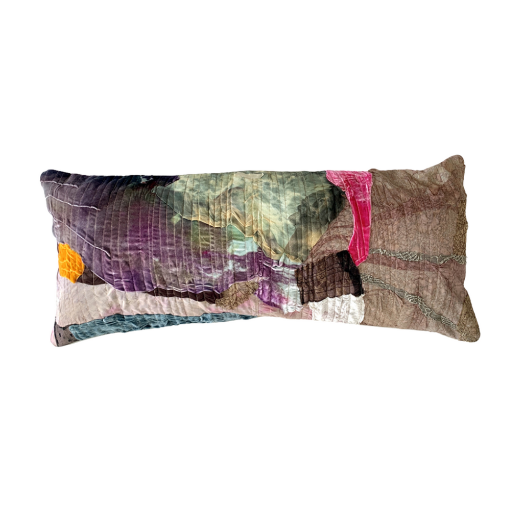 Multicolored patchwork pillow on a white background