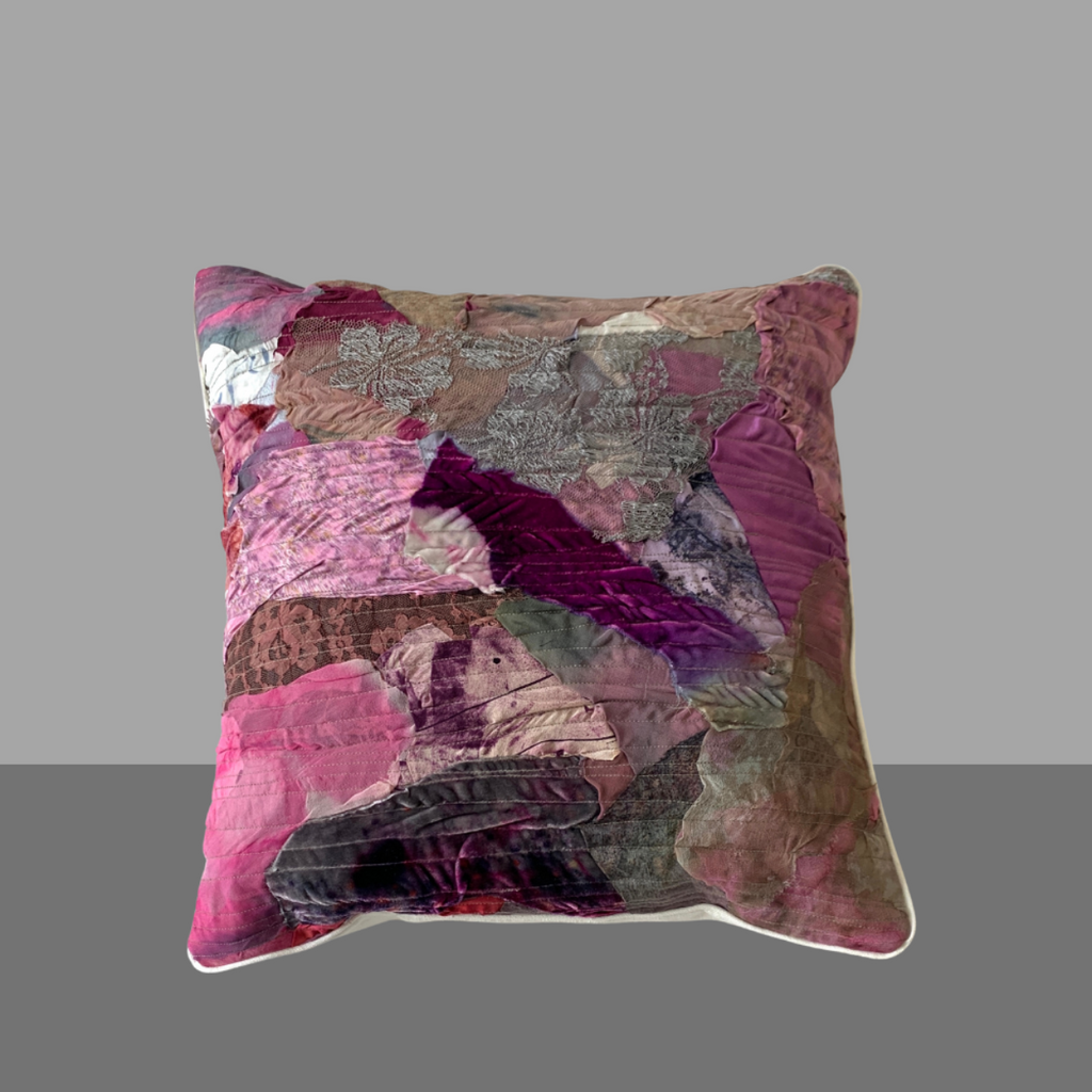 Multicolored patchwork pillow on a gray background