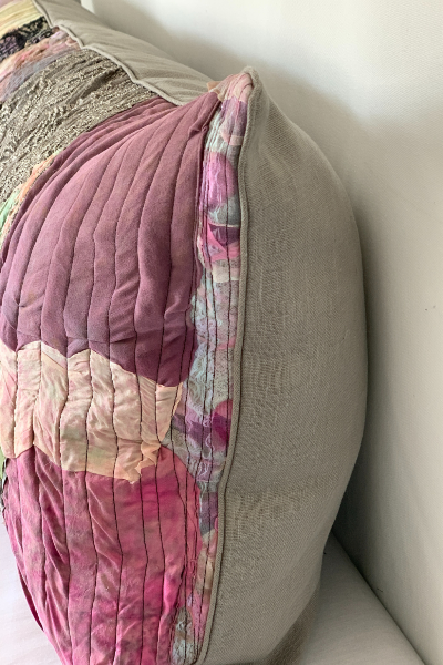 Floral-patterned quilt draped over a beige sofa
