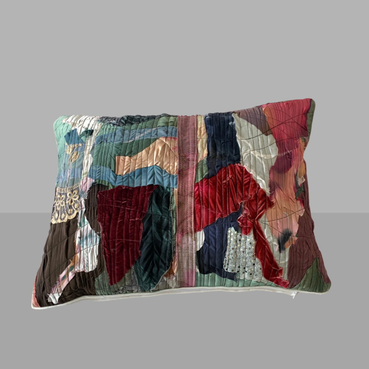 Multicolored textured pillow on a gray background