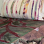 Colorful quilt with abstract pattern on a bed