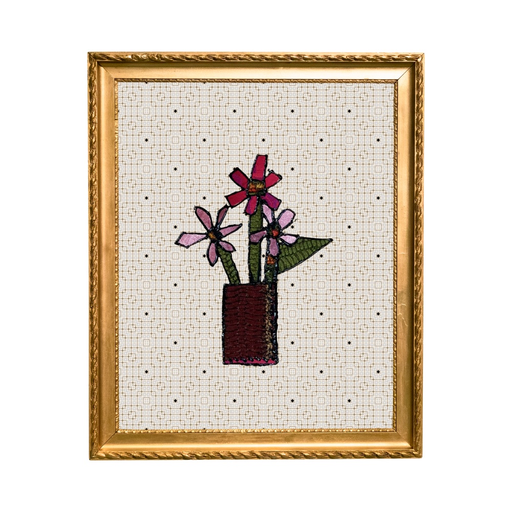 Framed cross-stitched artwork of flowers in a vase on a white background