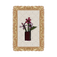 Cross-stitched design of flowers in a vase on a grid background with an ornate frame.