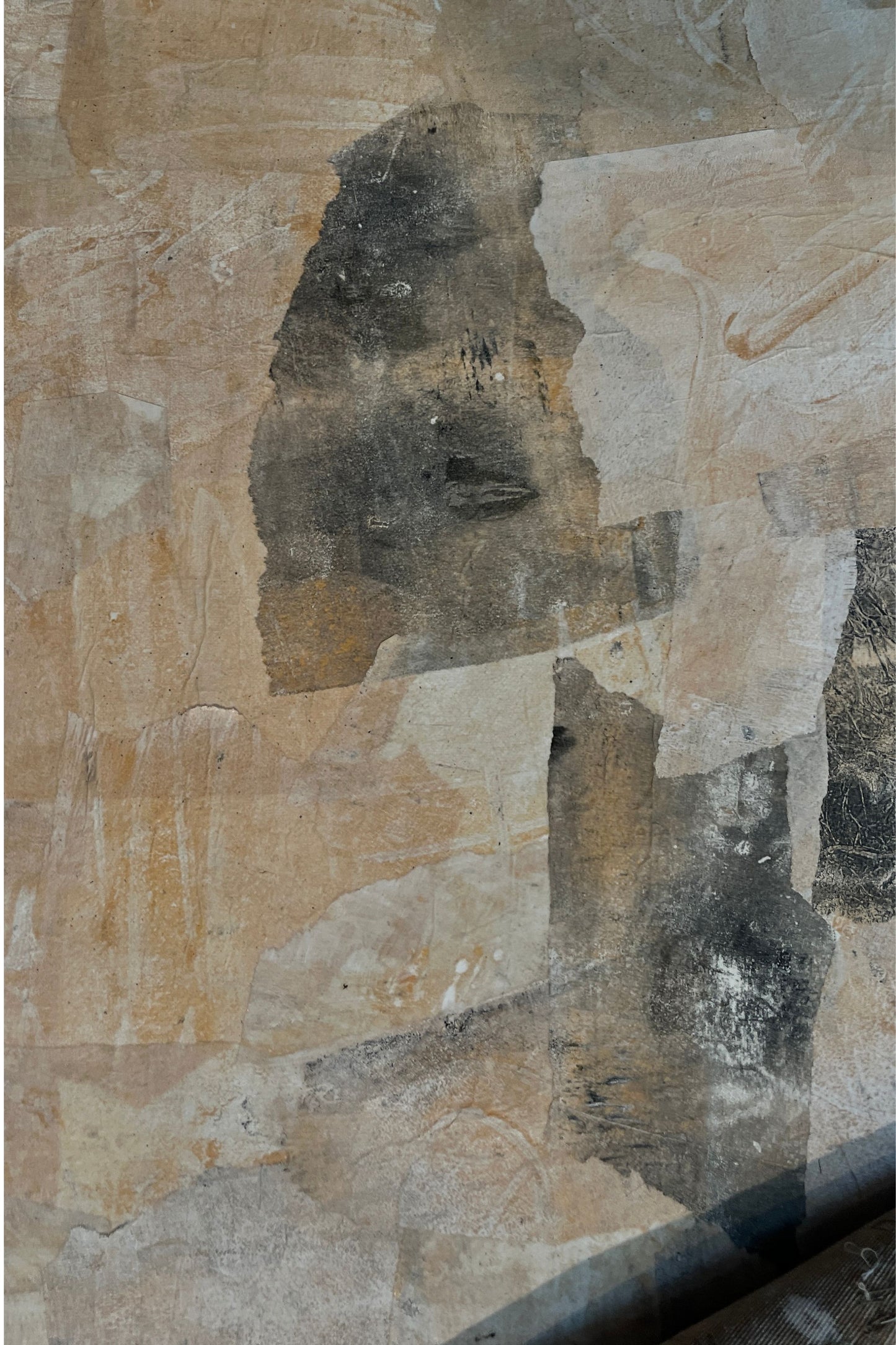 Abstract art piece with a mix of brown, black, and beige colors on a textured surface.