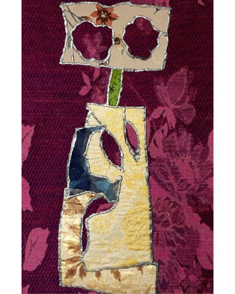 Collage artwork featuring a tall, sculptural yellow and gold vase with layered textile textures, topped by a floral cutout block against a deep plum floral-patterned background.
