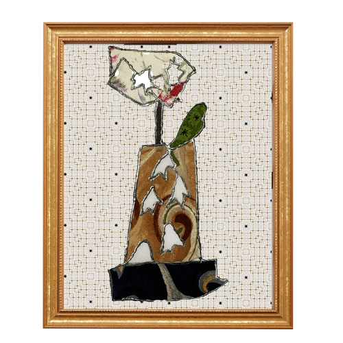 Framed abstract artwork with a central piece resembling a flower or plant on a white background