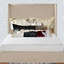 Bed with decorative pillows against a patterned wall