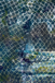 Close-up of a textured surface with geometric patterns in blue, green, and gray.