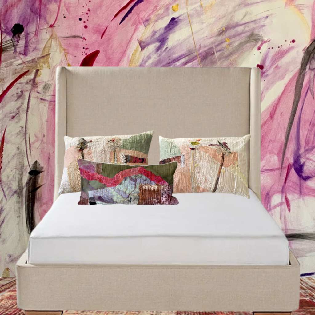 Beige bed with colorful pillows against a abstract art wall.