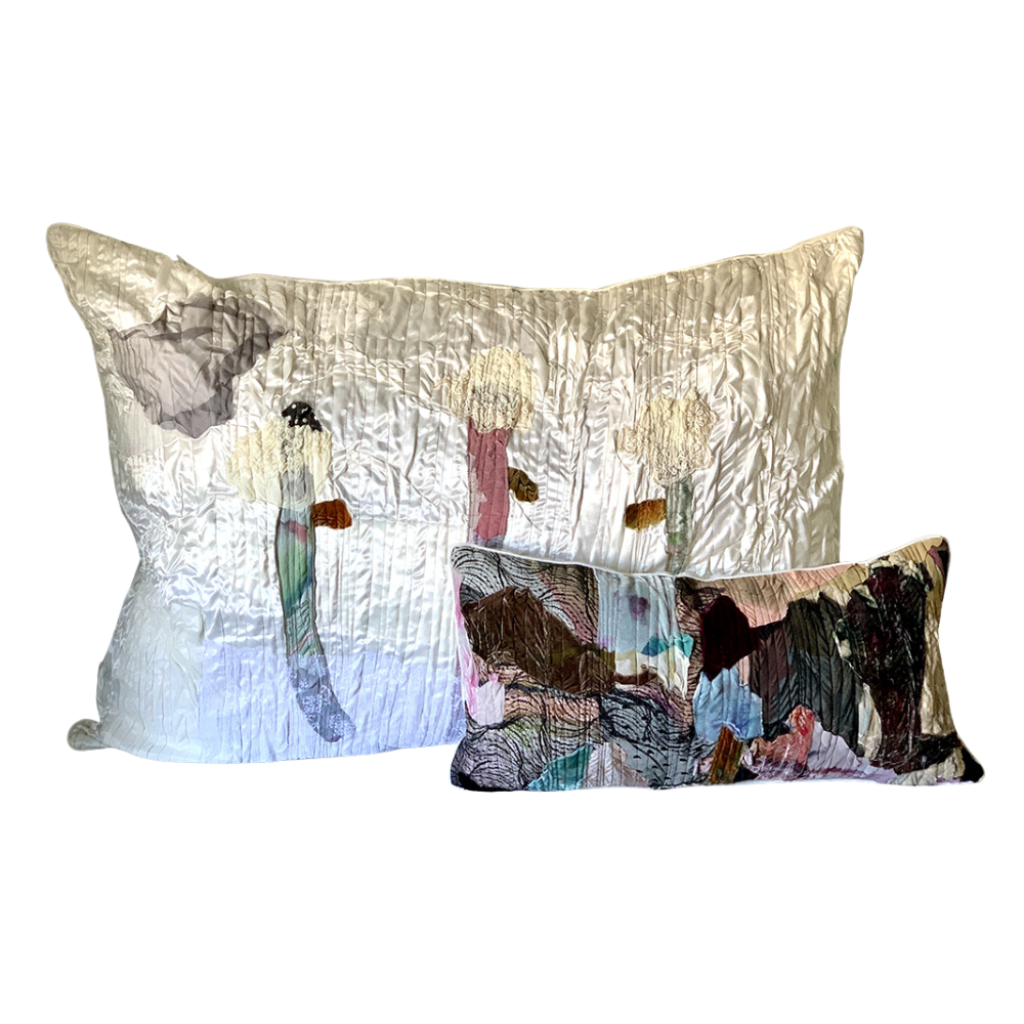 Two decorative pillows with artistic designs on a white background