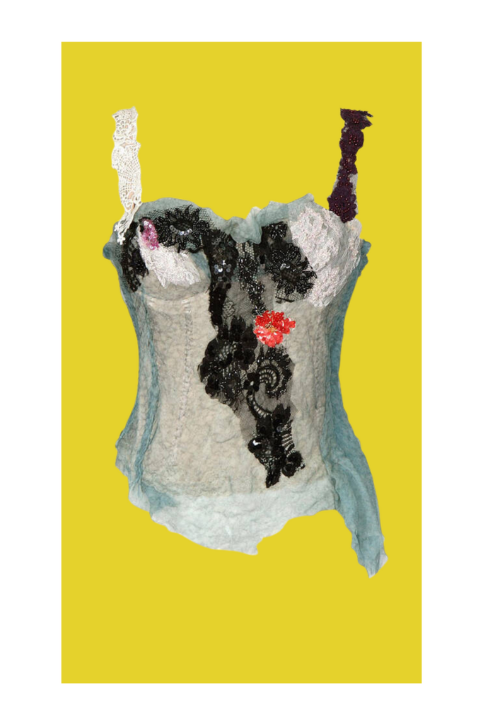 Decorative item resembling a corset with black and white pattern on a yellow background