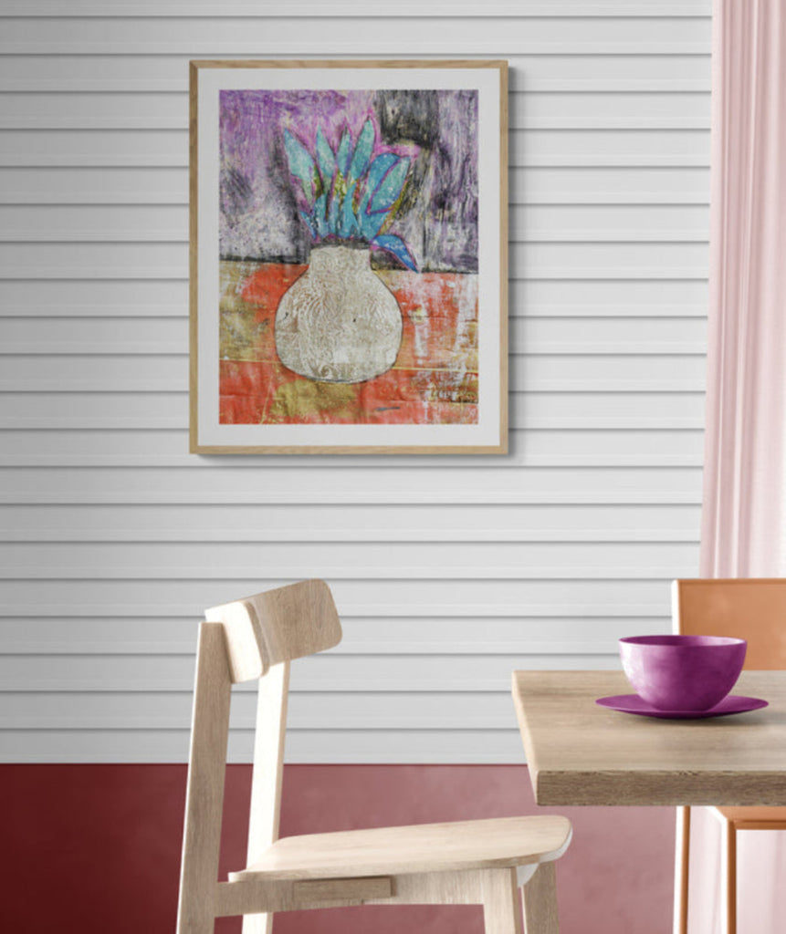 Mixed media collage titled Corn Moon by Sara Palacios. The artwork features a textured white vase with bold turquoise leaves set against a deep purple and gold background, blending rich colors and intricate patterns for a vibrant, earthy composition.