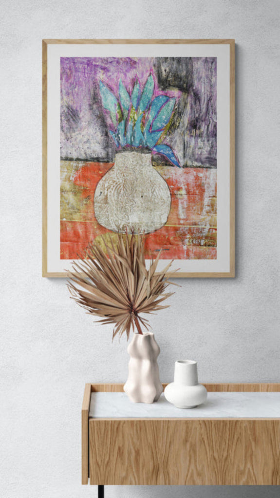Mixed media collage titled Corn Moon by Sara Palacios. The artwork features a textured white vase with bold turquoise leaves set against a deep purple and gold background, blending rich colors and intricate patterns for a vibrant, earthy composition.