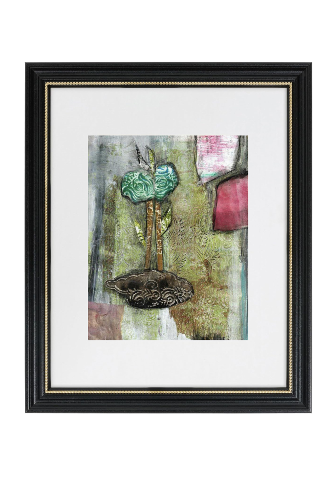 Framed artwork with a collage of objects on a white background