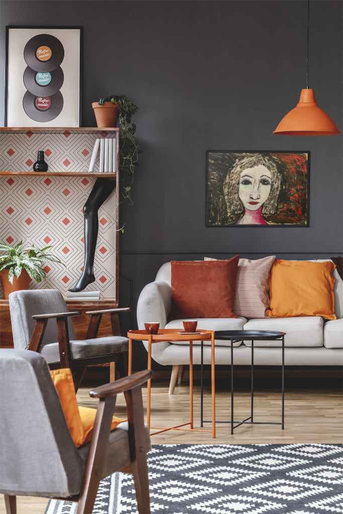 Portrait of a woman named Regina with red lips, expressive eyes, and textured black-and-red collage hair, against a dark painted background.