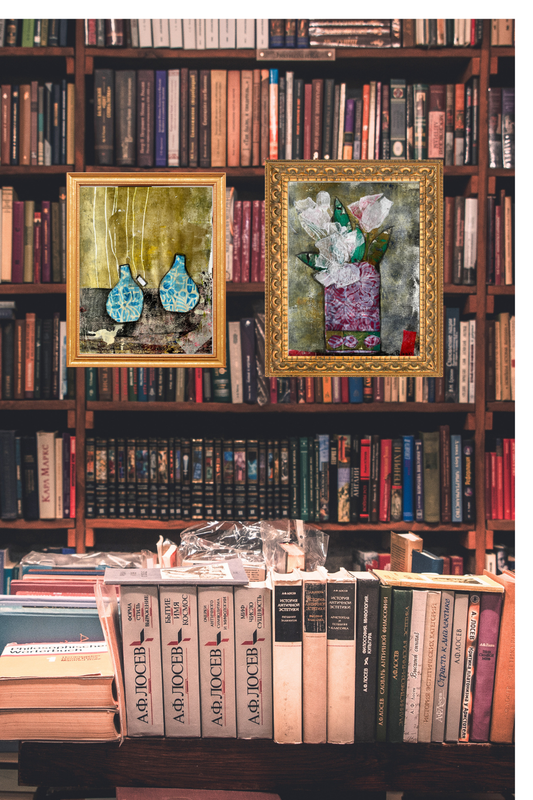 Two framed art prints in ornate golden frames hang on a library wall filled with books, showing how art adds warmth, depth, and personality to an interior space.