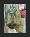 Mixed media collage titled Hay Moon by Sara Palacios. The piece features a stylized green flower with rose-like patterns, two tall stems, and layered leaves growing from a textured brown base. Surrounded by an abstract background of green, gray, and pink tones, the artwork blends organic and ornamental elements for a dreamy, earthy composition.