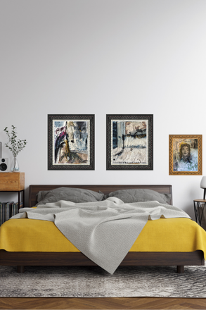 Bedroom with a bed, yellow blanket, and framed pictures on the wall.