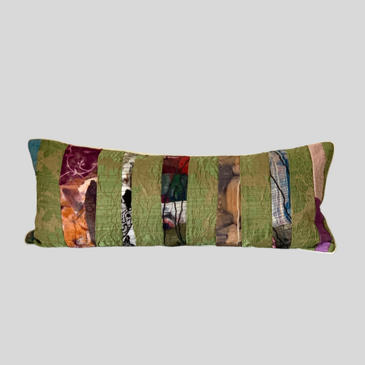 Colorful patchwork pillow on a light gray background