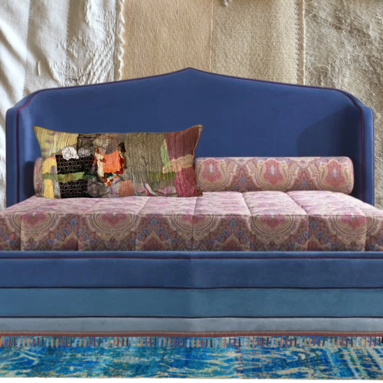 blue bed, with colorful cushions against a textured wall.