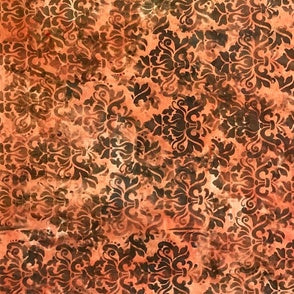 Decorative fabric with brown floral pattern on a red-orange background