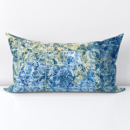 A rectangular lumbar throw pillow featuring a tropical leaf pattern in shades of blue and light green, set against a plain white background.