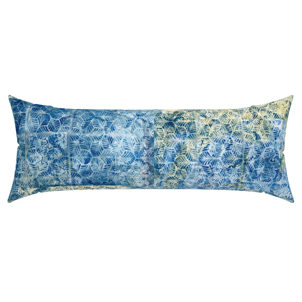 Long rectangular pillow with blue and green leaf pattern on a white background