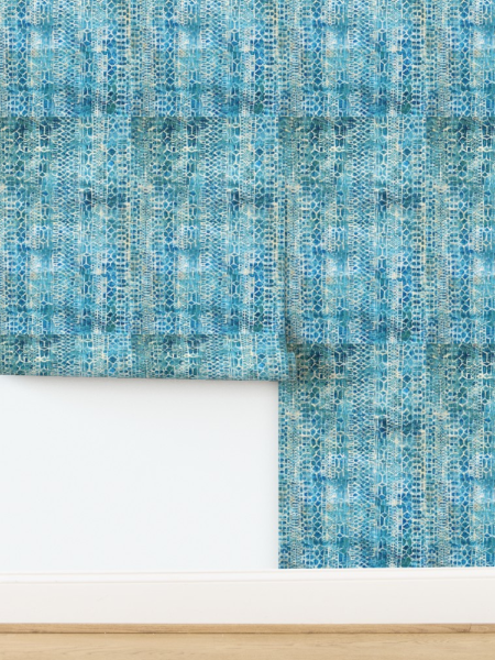 Textured blue wallpaper with a white border on a wooden surface