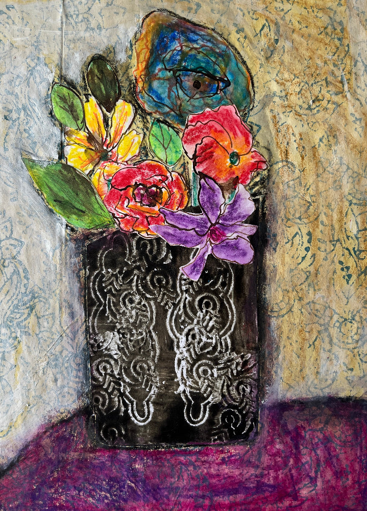 Colorful flowers in a decorative vase against a textured wall.