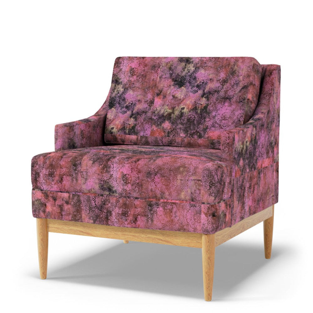 Pink patterned armchair with wooden legs on a white background