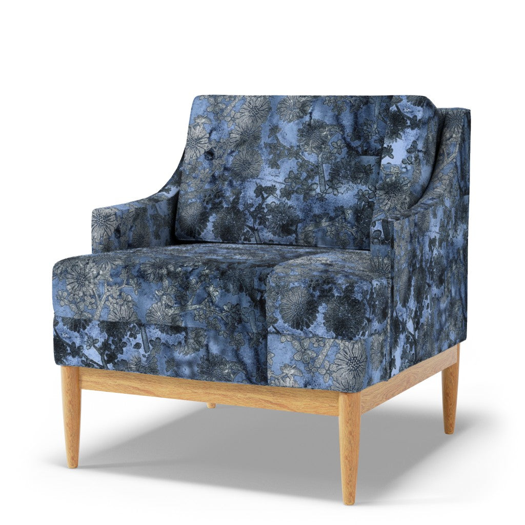 Blue patterned armchair with wooden legs on a white background