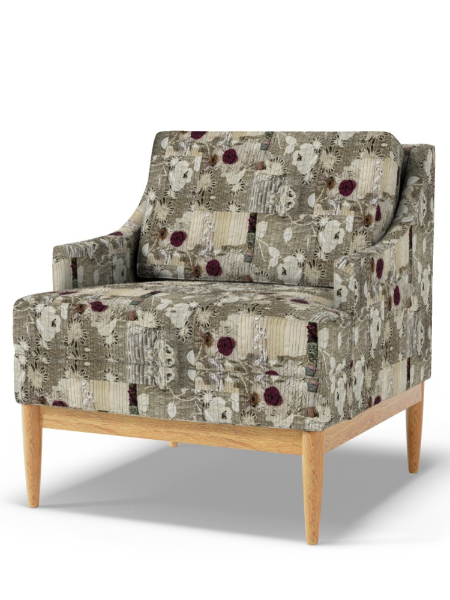 Floral patterned armchair with wooden legs on a white background