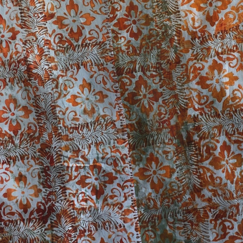 Patterned fabric with orange, white, and brown colors