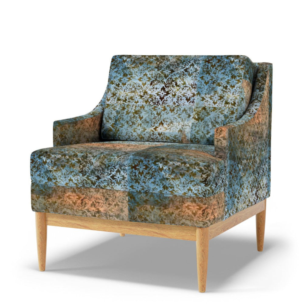 Floral-patterned armchair with wooden legs on a white background
