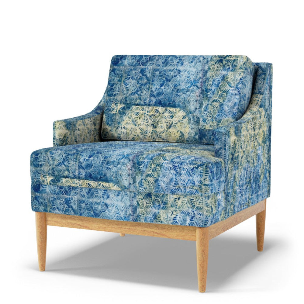 Blue patterned armchair with wooden legs on a white background