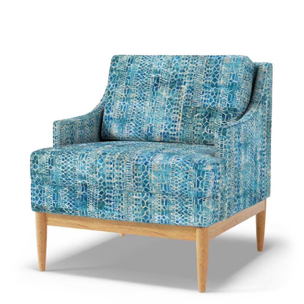 Blue patterned armchair with wooden legs on a white background