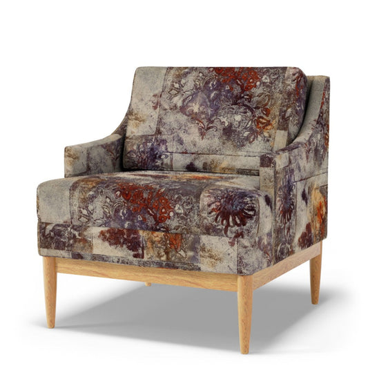 Patterned armchair with wooden legs on a white background