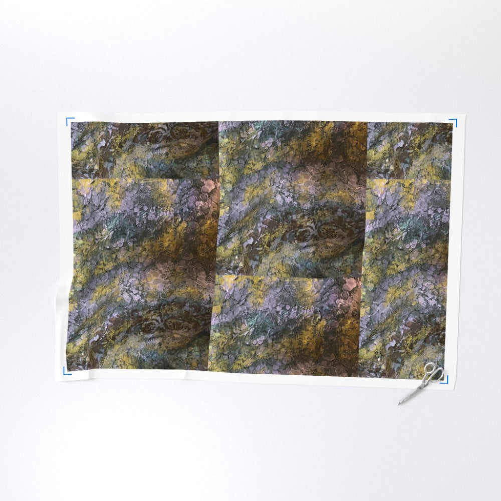 Textile with a patchwork pattern of green, brown, and gray on a white background