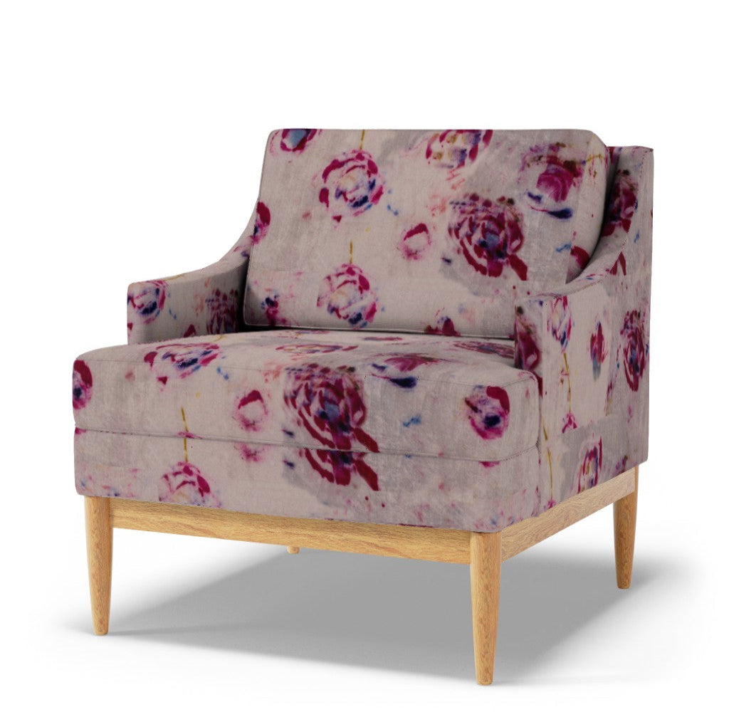 Floral patterned armchair with wooden legs on a white background