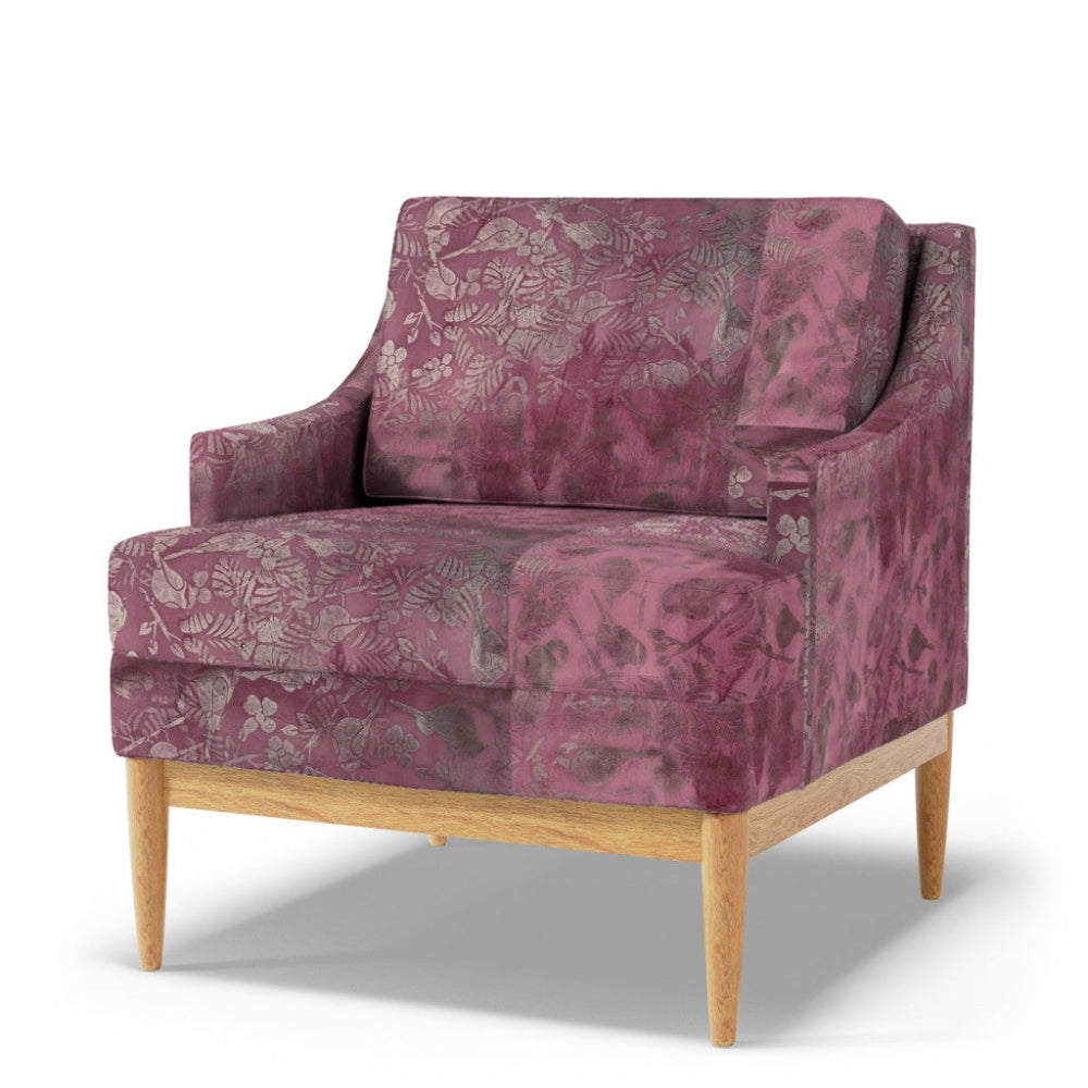 Purple patterned armchair with wooden legs on a white background