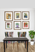 Dining room with a black table and colorful chairs, framed artwork on the wall.