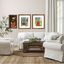 Living room with white sofa, wooden coffee table, and framed artwork on the wall.