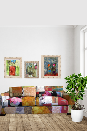 Living room with a colorful patchwork sofa, framed artwork on the wall, and a potted plant.