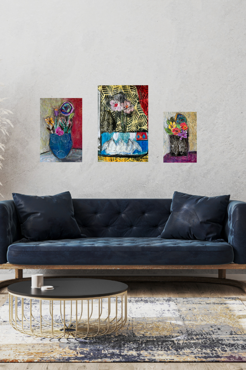Living room with a navy blue sofa, coffee table, and wall art featuring floral and abstract designs.