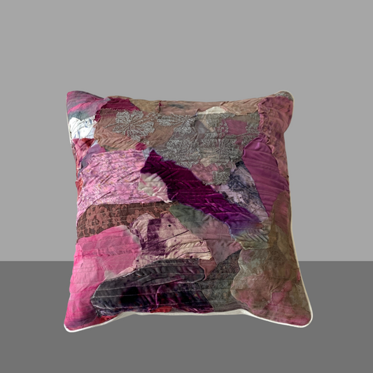 Multicolored patchwork pillow on a gray background