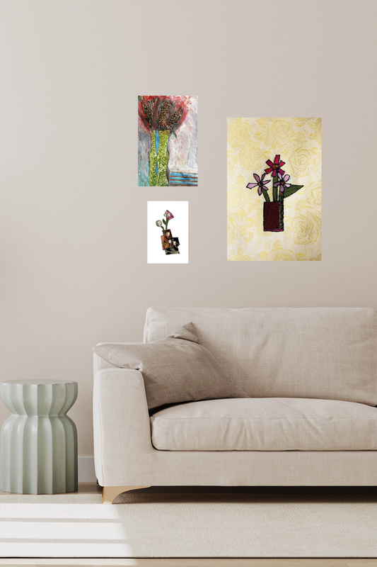 Three pieces of abstract art on a wall above a beige sofa.