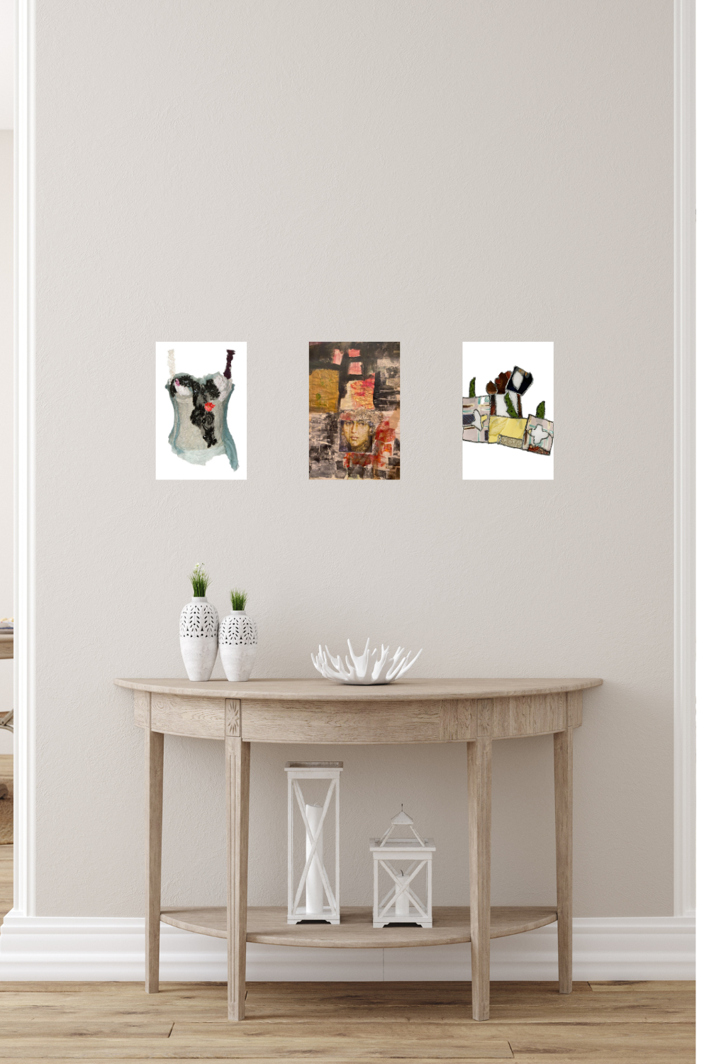 Three framed pictures on a wall above a wooden table with decorative items.