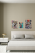 Bedroom with abstract art on the wall and a nightstand.