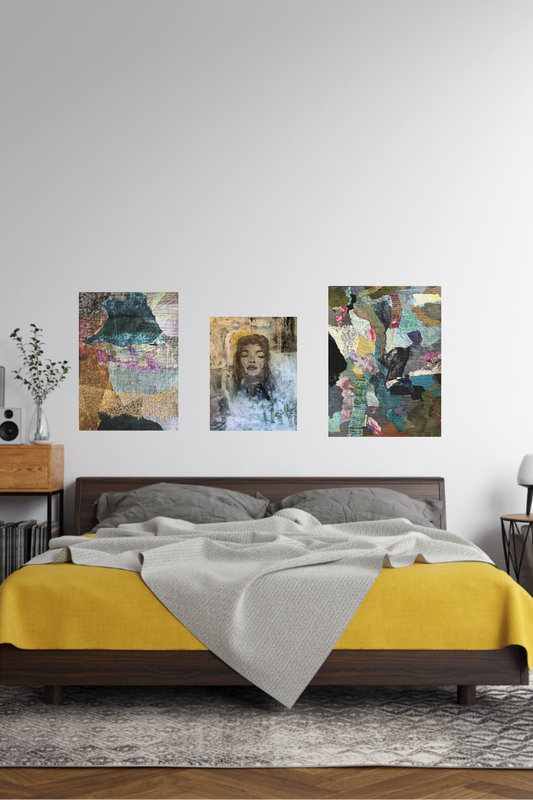 Bedroom with a bed featuring a yellow blanket and gray pillows, above which are three abstract art pieces on the wall.