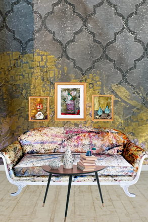 Decorative living room with patterned sofa, table, and wall art against a textured wall.